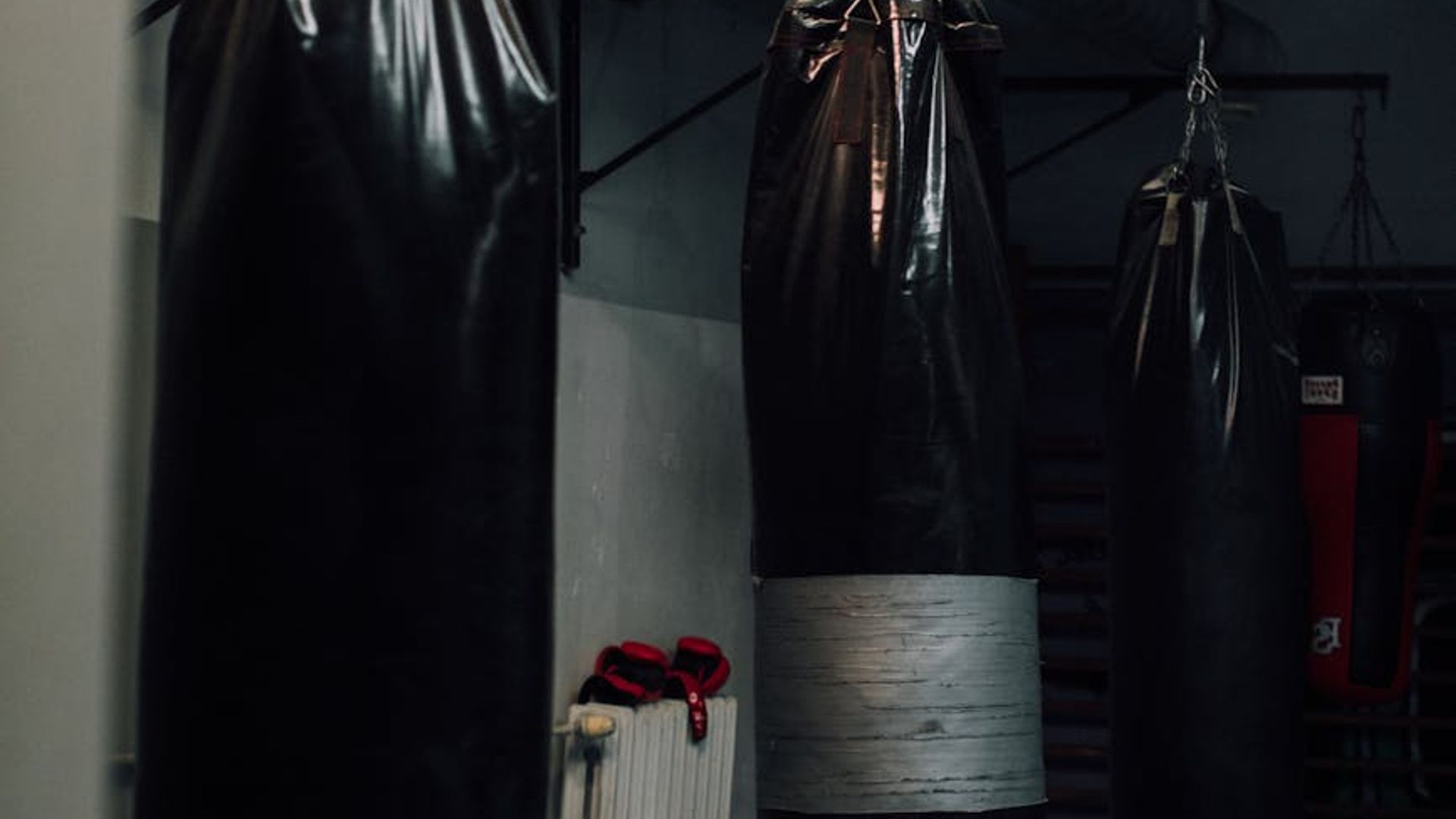 Atmospheric training space with moody lighting and professional equipment.